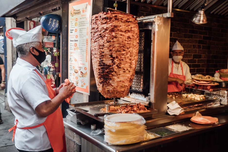 Al pastor meat roasting on a trompo