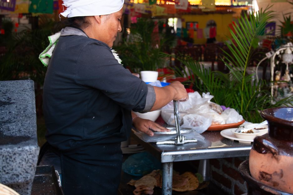 Hand-pressed corn tortillas on a comal
